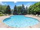 Community pool surrounded by lounge chairs, creating an inviting outdoor retreat for relaxation and recreation at 3825 Canyon Ranch Rd # 203, Highlands Ranch, CO 80126