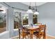 Cozy dining area with a wood table, chairs, pendant lights, and a large window offering outdoor views at 492 E 131St Ave, Thornton, CO 80241