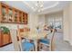 Elegant dining room with a glass table, chandelier, and built-in cabinets for a sophisticated dining experience at 492 E 131St Ave, Thornton, CO 80241