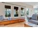 Bright living room featuring a built-in bench, large windows with views of the outdoor space and patio access at 492 E 131St Ave, Thornton, CO 80241