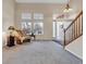 Inviting living room with soaring ceilings, large windows, and a staircase, perfect for entertaining and relaxation at 492 E 131St Ave, Thornton, CO 80241