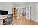 Functional home office with hardwood floors, a desk, and French doors opening to the staircase at 492 E 131St Ave, Thornton, CO 80241