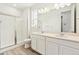 Bathroom with a glass shower, dual sinks, modern vanity, and bright vanity lighting at 9742 Cathay St, Commerce City, CO 80022