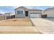 Charming single Gathering home features a two-car garage and stone exterior accents at 9742 Cathay St, Commerce City, CO 80022