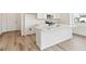 Kitchen island featuring stainless steel appliances, white cabinetry, and open layout concept at 9742 Cathay St, Commerce City, CO 80022