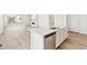 Bright kitchen island featuring stainless steel appliances and convenient stainless steel dishwasher at 9742 Cathay St, Commerce City, CO 80022