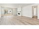 Living room featuring a modern fireplace, luxury vinyl plank flooring, and ample sunlight at 9742 Cathay St, Commerce City, CO 80022