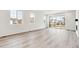 Living room featuring luxury vinyl plank flooring, bright natural light, and ample room at 9742 Cathay St, Commerce City, CO 80022