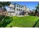 Spacious backyard with grass and multi-level patios, spiral staircase, and well-maintained landscaping at 4814 S Upham Ct, Littleton, CO 80123