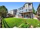 Well-manicured backyard featuring a lawn, multi-level decks, and professional landscaping at 4814 S Upham Ct, Littleton, CO 80123