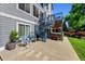 Backyard with a spiral staircase, hot tub, concrete patio, and well-maintained lawn on a sunny day at 4814 S Upham Ct, Littleton, CO 80123
