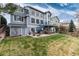 Spacious backyard featuring a hot tub, spiral staircase, and grassy area for outdoor enjoyment at 4814 S Upham Ct, Littleton, CO 80123