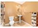 Cozy bathroom featuring a pedestal sink, tile floor, toilet, towel rack, and shower at 4814 S Upham Ct, Littleton, CO 80123