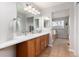 Bright bathroom with dual sinks, tile flooring, and a separate shower and tub at 4814 S Upham Ct, Littleton, CO 80123