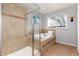 Tiled bathroom featuring a soaking tub and a glass-enclosed shower at 4814 S Upham Ct, Littleton, CO 80123