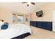 Bright bedroom featuring serene lake views, two dressers, and a ceiling fan at 4814 S Upham Ct, Littleton, CO 80123