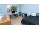 A blue bedroom featuring a desk with a computer, a dresser, and a bed at 4814 S Upham Ct, Littleton, CO 80123