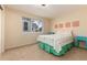 Cozy bedroom with neutral walls and a view of the outdoors at 4814 S Upham Ct, Littleton, CO 80123