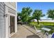 Spacious deck with glass railings offering views of the green grass down to the lake beyond at 4814 S Upham Ct, Littleton, CO 80123