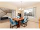 Elegant dining room with stylish chairs, large window and chandelier creating a great ambiance at 4814 S Upham Ct, Littleton, CO 80123