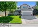 Charming two-story home boasts a manicured lawn, a two-car garage and inviting front porch with beautiful curb appeal at 4814 S Upham Ct, Littleton, CO 80123