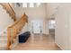 Open foyer with hardwood flooring, natural light, and staircase at 4814 S Upham Ct, Littleton, CO 80123