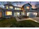 Inviting two-story home with a covered porch, manicured lawn, and a cozy seating area at 4814 S Upham Ct, Littleton, CO 80123