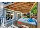 Outdoor hot tub area with privacy surround and seating, accessible via spiral staircase at 4814 S Upham Ct, Littleton, CO 80123