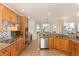 Open kitchen with stainless dishwasher, view, cooktop, and granite countertops at 4814 S Upham Ct, Littleton, CO 80123