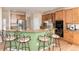 Open-concept kitchen with counter seating, stainless steel appliances, and plenty of storage at 4814 S Upham Ct, Littleton, CO 80123