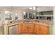 Modern kitchen featuring granite countertops, wooden cabinetry, stainless steel appliances, and natural lighting at 4814 S Upham Ct, Littleton, CO 80123