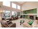 Spacious living room with large windows offering stunning views and a cozy fireplace at 4814 S Upham Ct, Littleton, CO 80123
