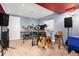 Music room with drum set, keyboard, guitar, speakers, and blue walls at 4814 S Upham Ct, Littleton, CO 80123