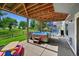 Covered backyard patio with hot tub and access to an outdoor spiral staircase at 4814 S Upham Ct, Littleton, CO 80123