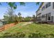 Large backyard with a wooden fence, mature trees, green grass and access to a wood deck at 19131 E Garden Pl, Centennial, CO 80015