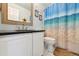 Well-lit bathroom featuring granite countertop vanity and shower with an ocean-themed curtain at 19131 E Garden Pl, Centennial, CO 80015