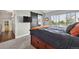 Bright bedroom with large window, custom sliding door, and built-in bed drawers at 19131 E Garden Pl, Centennial, CO 80015