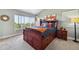 Serene bedroom featuring a large window with treetop views and built-in storage in bed frame at 19131 E Garden Pl, Centennial, CO 80015