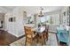 Dining room with a glass table, wooden chairs, hardwood floors, and a large window at 19131 E Garden Pl, Centennial, CO 80015