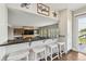 Bright kitchen pass through featuring black granite countertops and sleek white cabinetry at 19131 E Garden Pl, Centennial, CO 80015