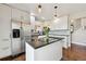 Modern kitchen with white cabinets, stainless steel appliances, and granite countertops with a view to the backyard at 19131 E Garden Pl, Centennial, CO 80015