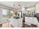 Bright, modern kitchen featuring white cabinets, stainless steel appliances, and an island at 19131 E Garden Pl, Centennial, CO 80015