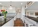 Well-lit kitchen featuring an eat-in bar, granite countertops and stainless steel appliances at 19131 E Garden Pl, Centennial, CO 80015