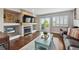 Cozy living room featuring a fireplace, deck access, and hardwood floors at 19131 E Garden Pl, Centennial, CO 80015