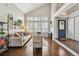 Open-concept living room with high ceilings, hardwood floors, and bright natural light at 19131 E Garden Pl, Centennial, CO 80015