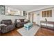 Comfortable living room featuring hardwood floors, a cozy seating area, and bright natural light at 19131 E Garden Pl, Centennial, CO 80015