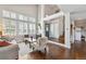 Spacious living room with tall ceilings, large windows, hardwood flooring, and an open entryway at 19131 E Garden Pl, Centennial, CO 80015