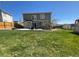 Large backyard with lush green grass and a patio provides ample space for outdoor activities at 4614 Lyndenwood Cir, Highlands Ranch, CO 80130
