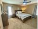 Comfortable bedroom with a wooden bed frame, neutral decor, and soft lighting at 4614 Lyndenwood Cir, Highlands Ranch, CO 80130