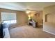 Spacious bedroom featuring neutral carpet, a window, and a ceiling fan at 4614 Lyndenwood Cir, Highlands Ranch, CO 80130